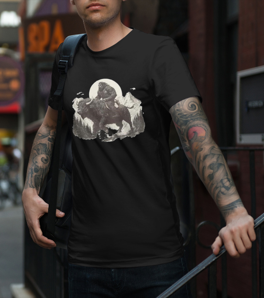 Blurry Creatures Bigfoot Riding Buffalo With Mountains And Moon In Background T-Shirt