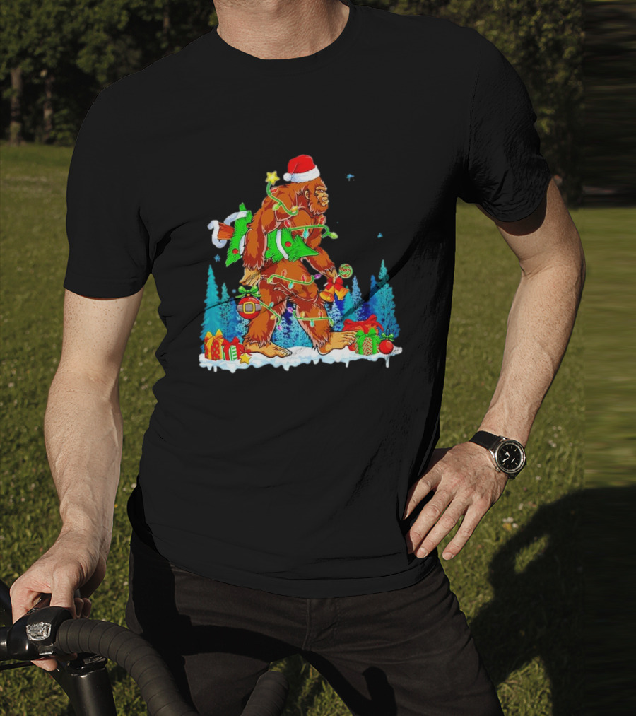 Bigfoot Santa Hugging Christmas Tree With Gifts And Snow Scene T-Shirt