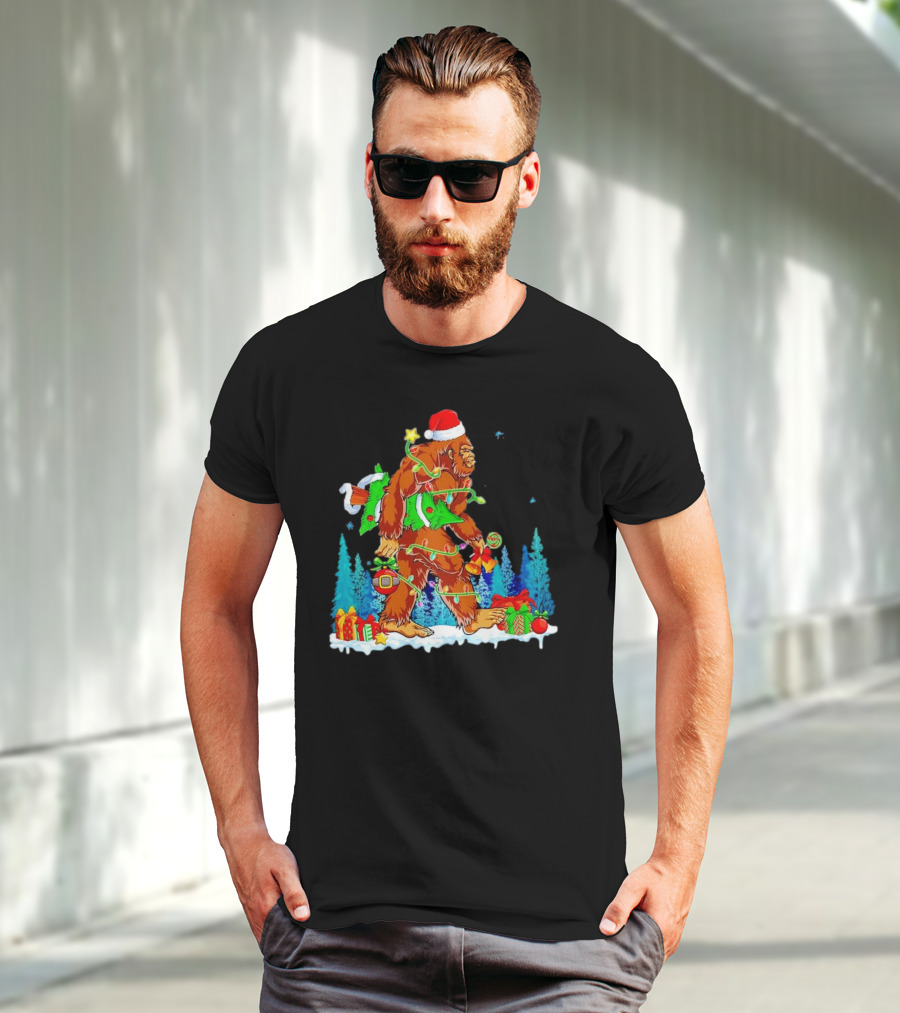 Bigfoot Santa Hugging Christmas Tree With Gifts And Snow Scene T-Shirt