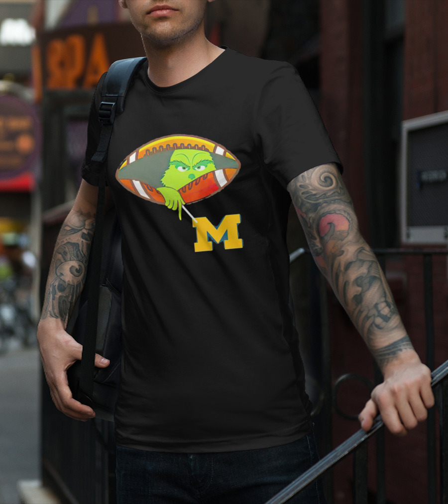 Grinch Peeking From Football Over Michigan Wolverines T-Shirt